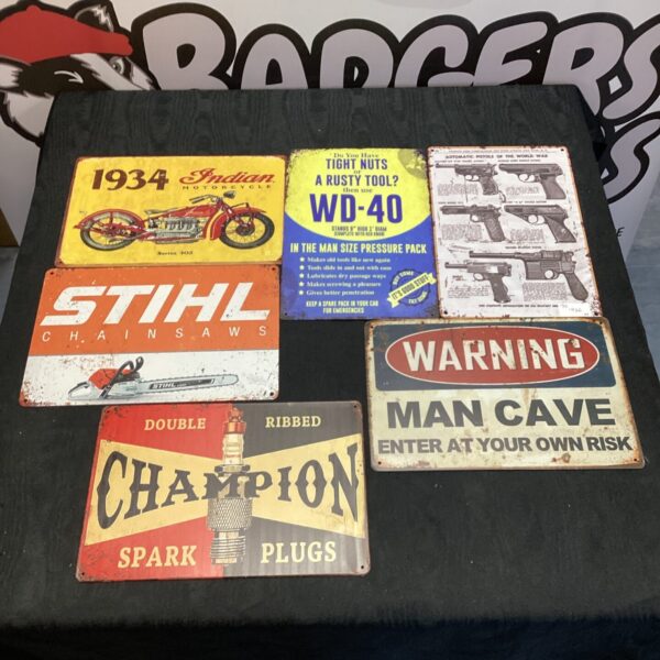 Collection of vintage advertising signs including Stihl, Champion, and WD-40.