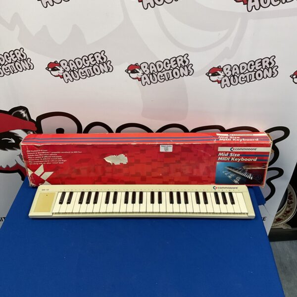 Vintage Commodore 121 midi keyboard in its original box.