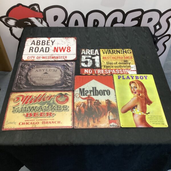 Vintage advertising signs lot including Marlboro, Playboy, and Abbey Road.