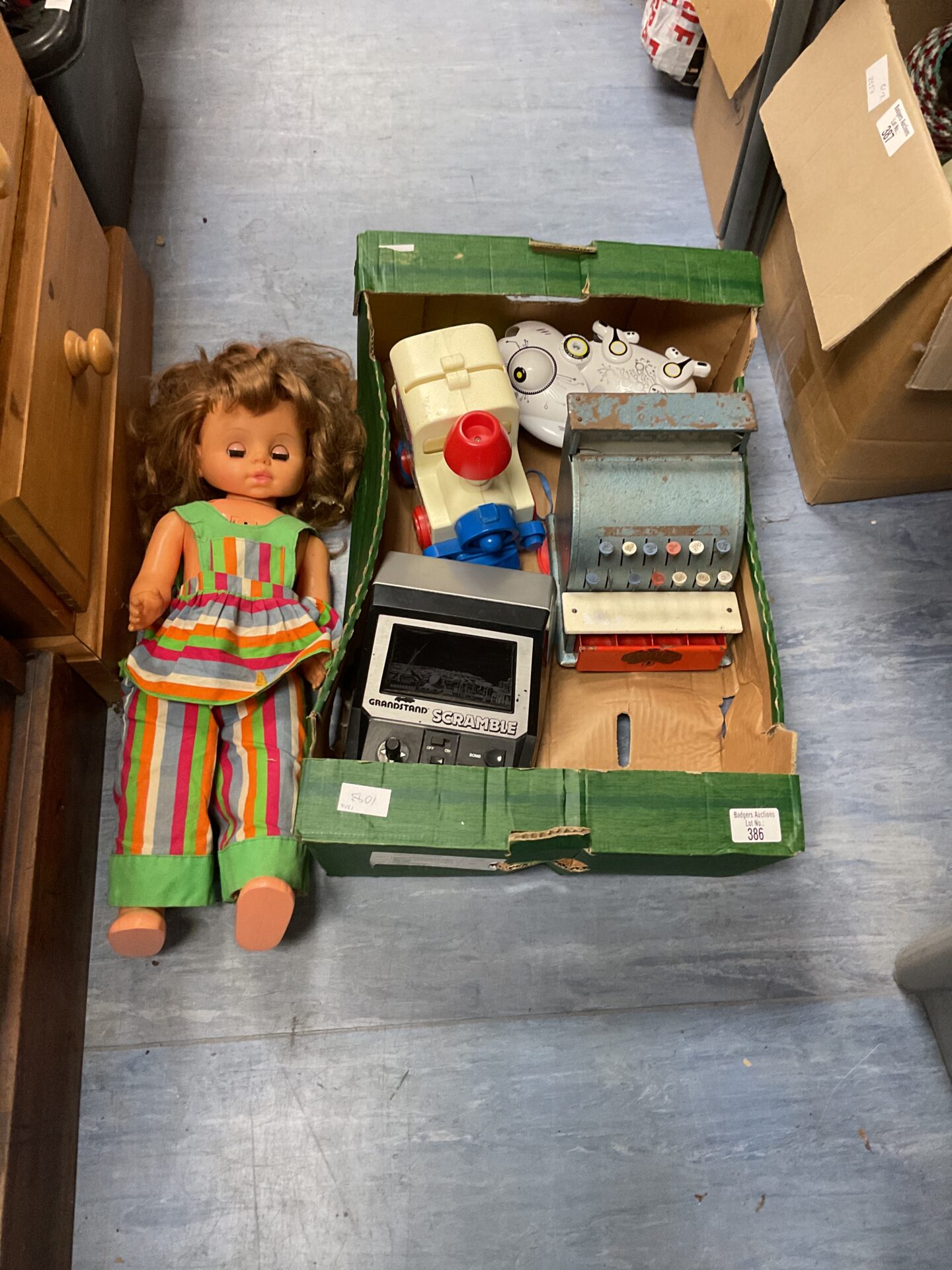 386 Box of mixed toys inc doll and vintage cash register