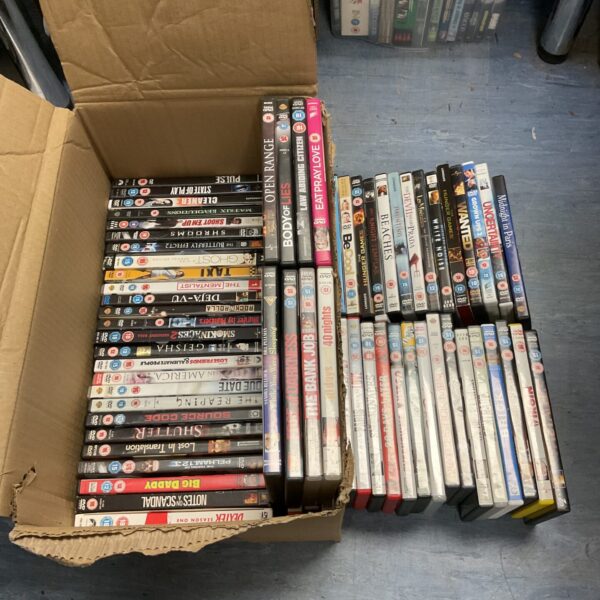 A collection of DVD movies in a box.