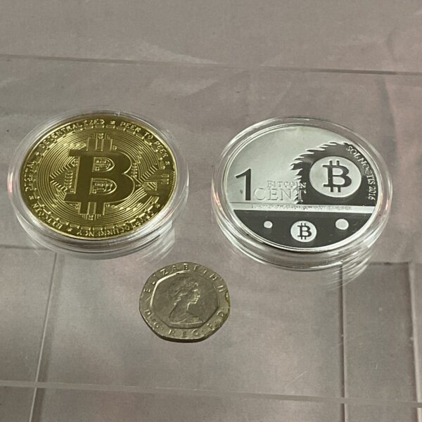 Gold plated Bitcoin commemorative coin with detailed design.