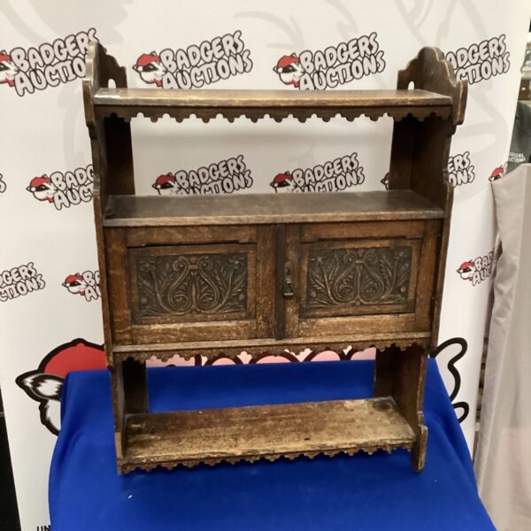 Vintage Art Nouveau mahogany bookcase with intricate carvings.