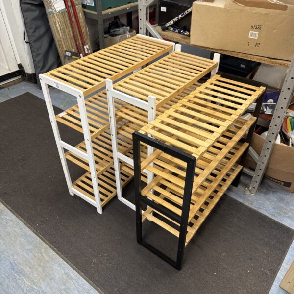 Front view of a wooden three-tiered shoe rack.