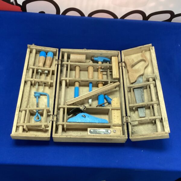 Vintage child's woodwork tool set in wooden case with miniature tools.
