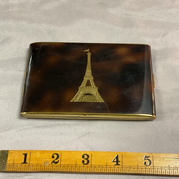 Vintage Eiffel Tower cigarette case with tortoise shell pattern.