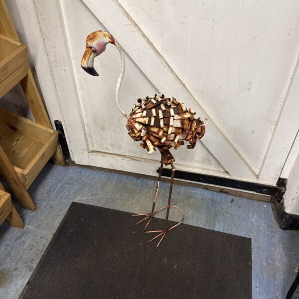 Metal garden flamingo ornament with a retro aesthetic.
