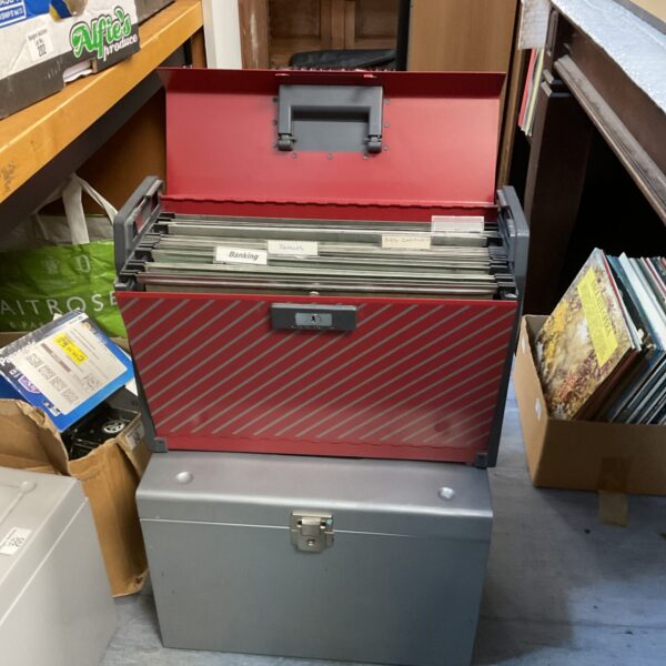 Two vintage metal filing boxes for document storage.