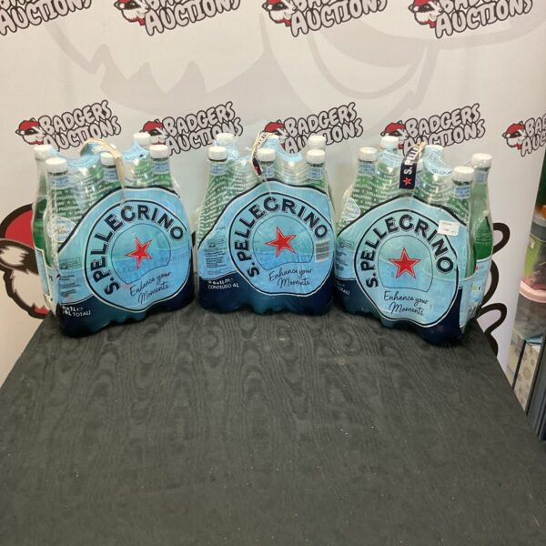 Collection of San Pellegrino sparkling water bottles in a lot.