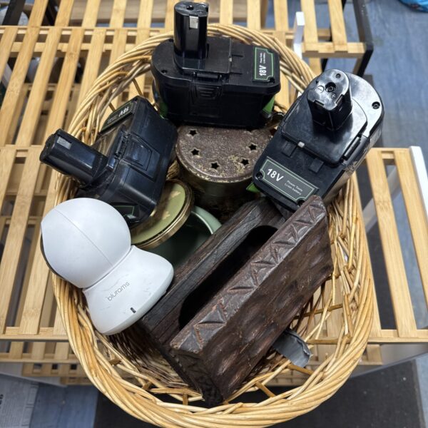 Vintage wicker basket filled with collectibles and a trinket box.
