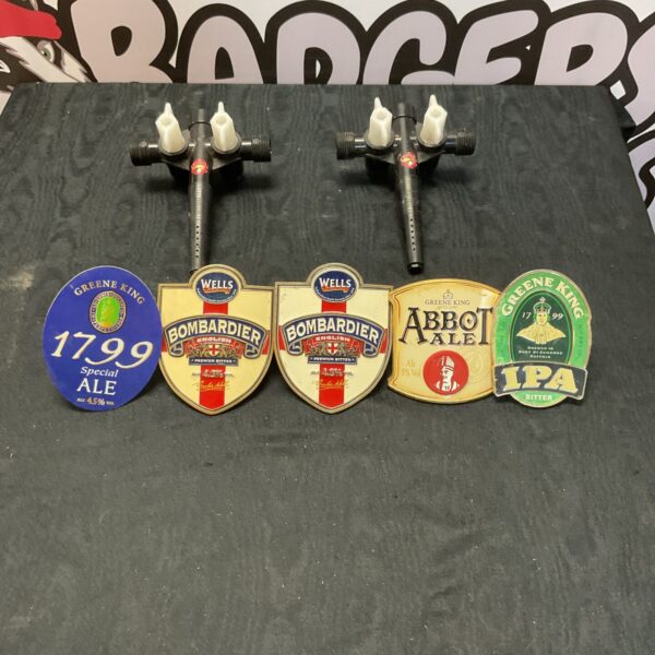 Vintage beer pump signs featuring the Bombardier brand in a collection.