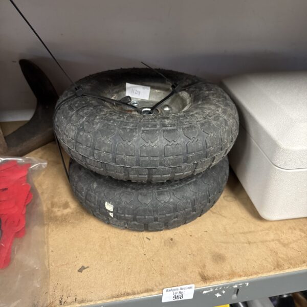 Pair of used pneumatic wheelbarrow wheels for garden use.