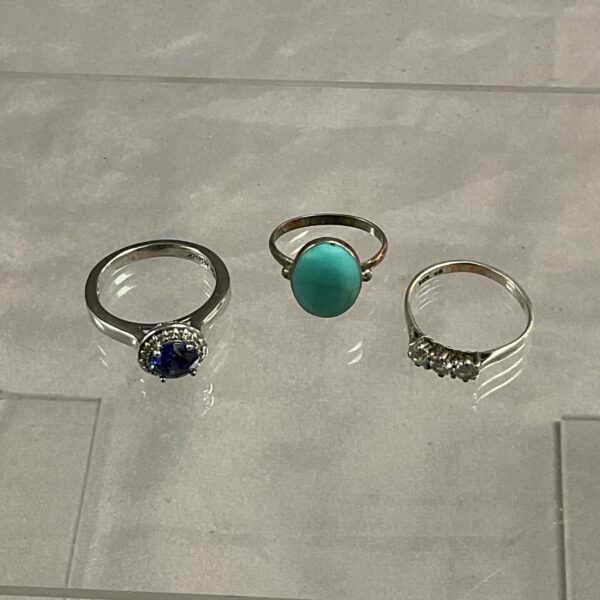 Silver stone set rings in sizes L, M, and P.