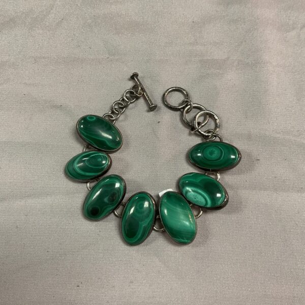 Vintage silver bracelet with vibrant green malachite stones.