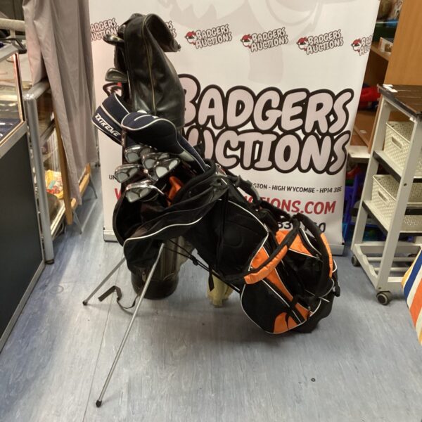 Vintage golf clubs with bags, Northwest brand set displayed.