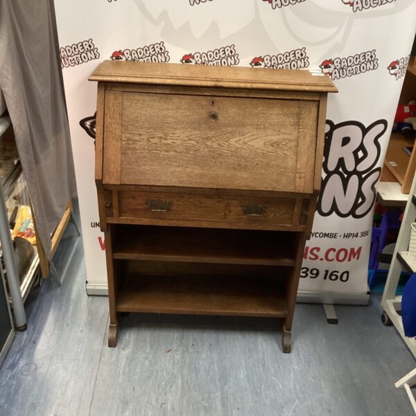 Front view of antique oak roll top writing desk.