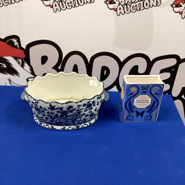 Vintage ceramic flower pot holder with blue and white floral design.
