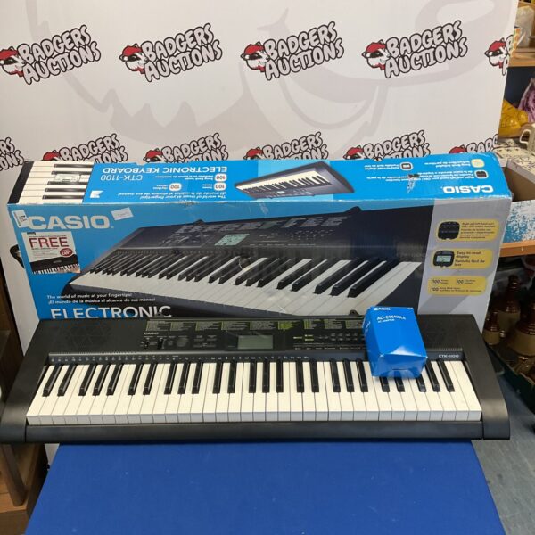 Casio CTK-1100 keyboard with power supply, a portable musical instrument.