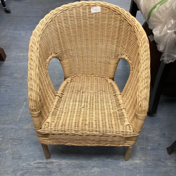 Vintage child's wicker chair with wooden legs.