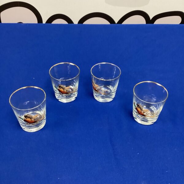 Set of four pheasant decorated tumblers for drinking.