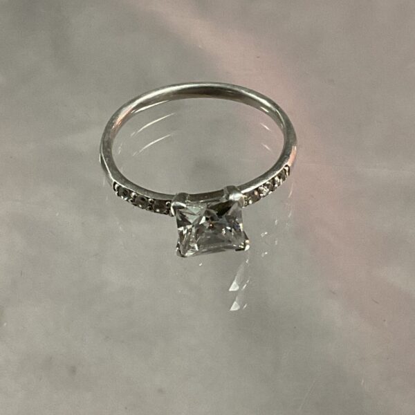 Close-up of a 935 silver ring with a white stone.