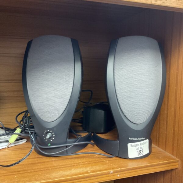 Black Harman Kardon PC speaker pair for computer audio.
