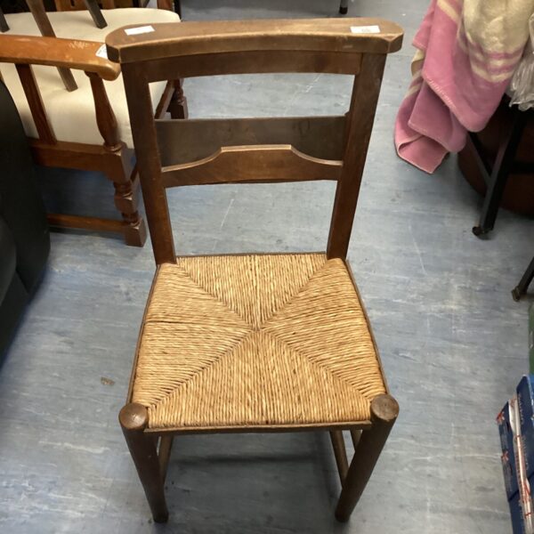Antique oak chapel chair with rush seat, vintage church seating.