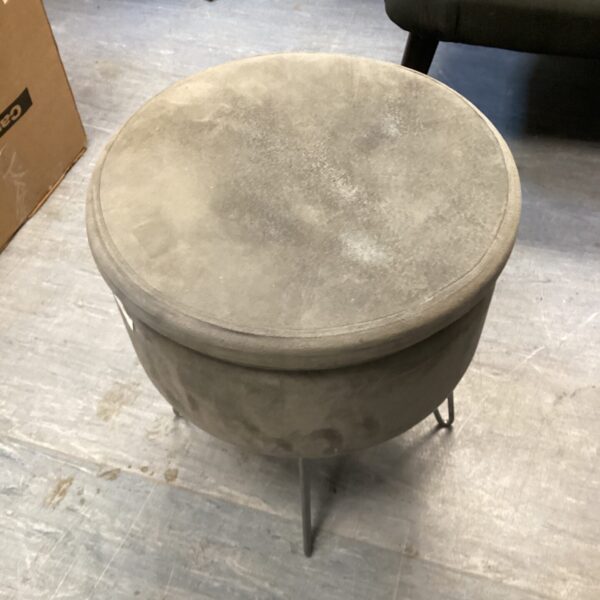 Grey upholstered storage stool for home decor and seating.