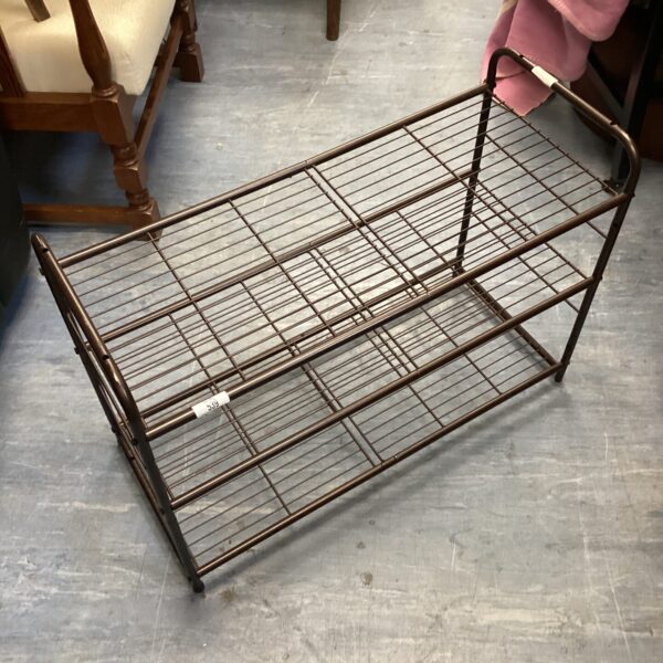 Tiered metal shoe rack for hallway or bedroom storage.