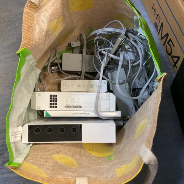 Two Nintendo Wii consoles and cables for retro gaming.