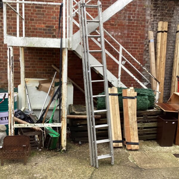 Used extending aluminium ladder leaning against brick wall.