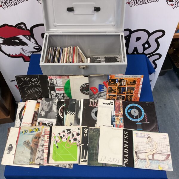 Vintage vinyl record collection featuring Sex Pistols singles and other punk rock artists.