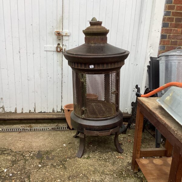 Large metal patio wood burner for outdoor garden use.