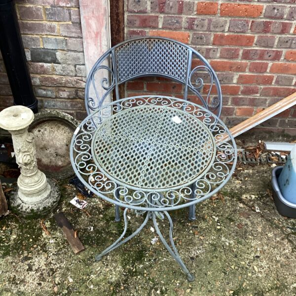 Vintage metal garden table and chairs with pierced detailing.