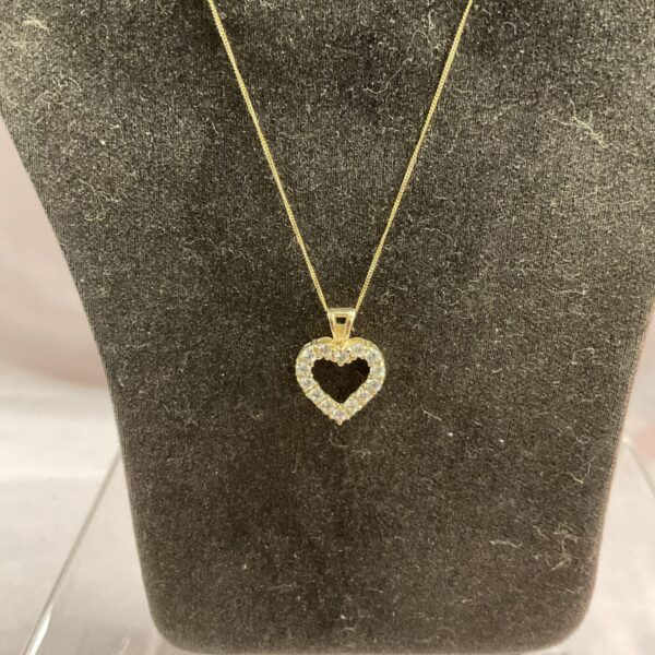 Sparkling 9ct gold heart necklace with white stones.