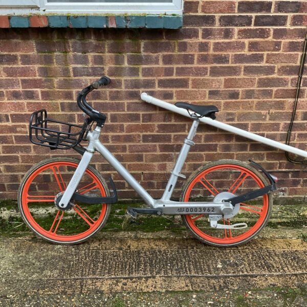 Mobile city bicycle with vibrant orange wheels for urban commuting.