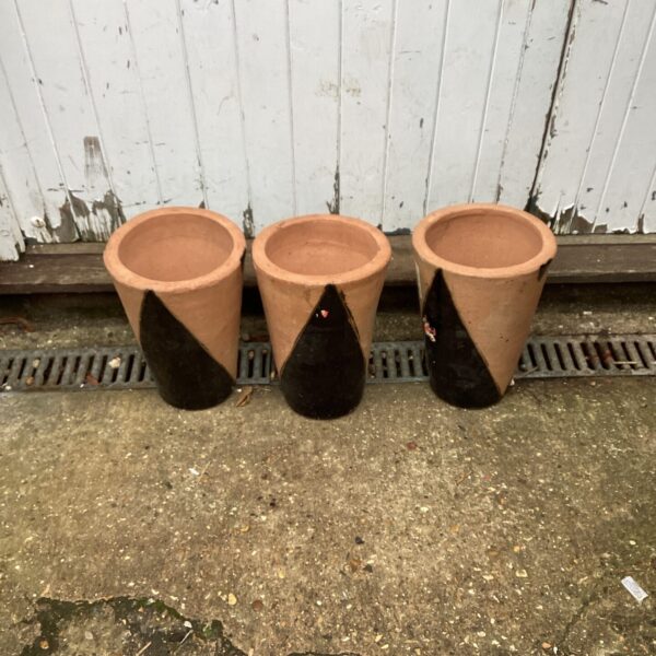 Lot of three vintage terracotta plant pots for gardening.