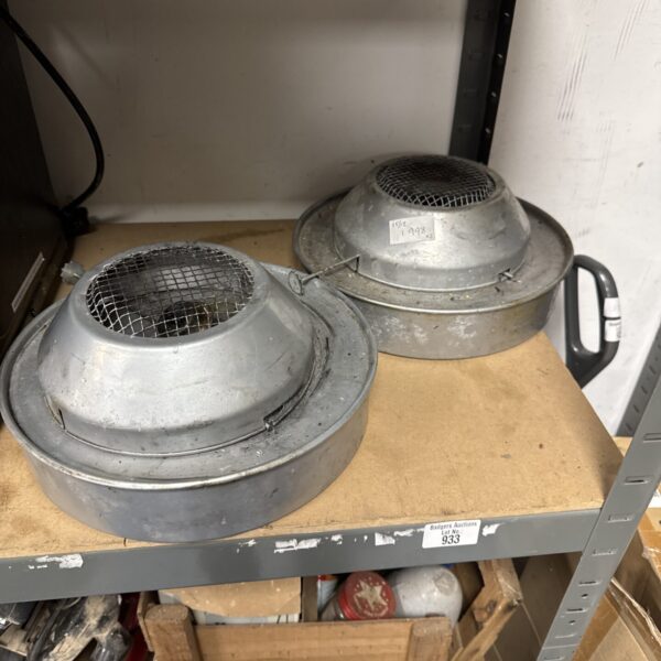 Two vintage metal paraffin greenhouse heaters for garden use.