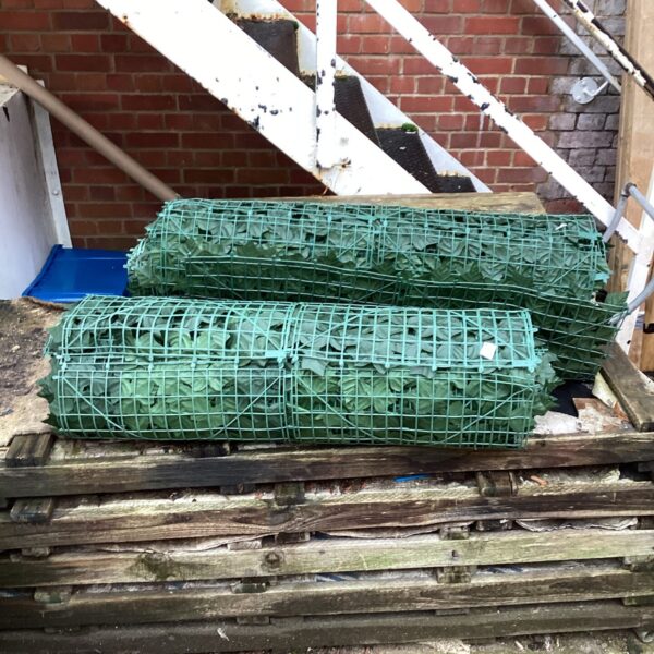 Two rolls of garden wall cover for privacy screening.