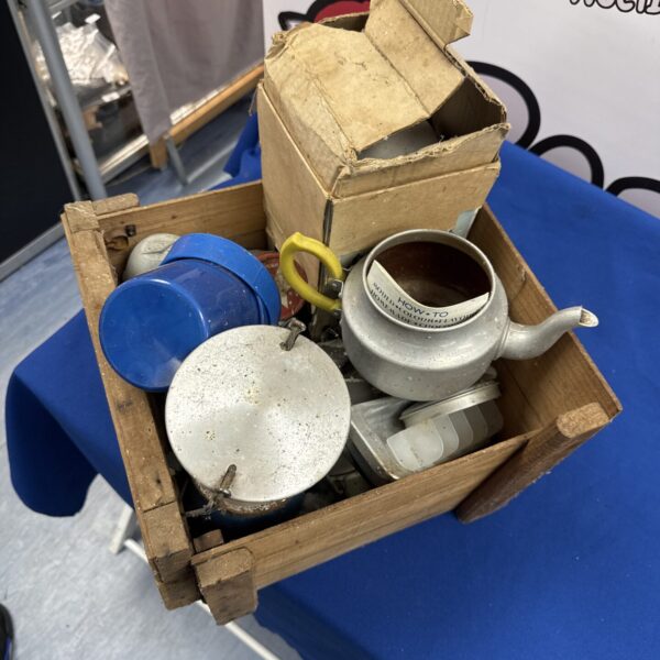 Vintage camping equipment lot with enamel kettle and wooden box.