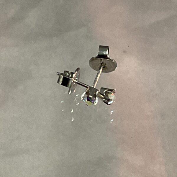 Close-up of 9ct white gold stud earrings with a butterfly fastening.