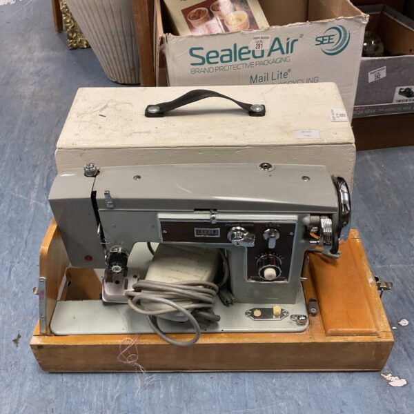 Vintage Acadex electric sewing machine in carrying case.