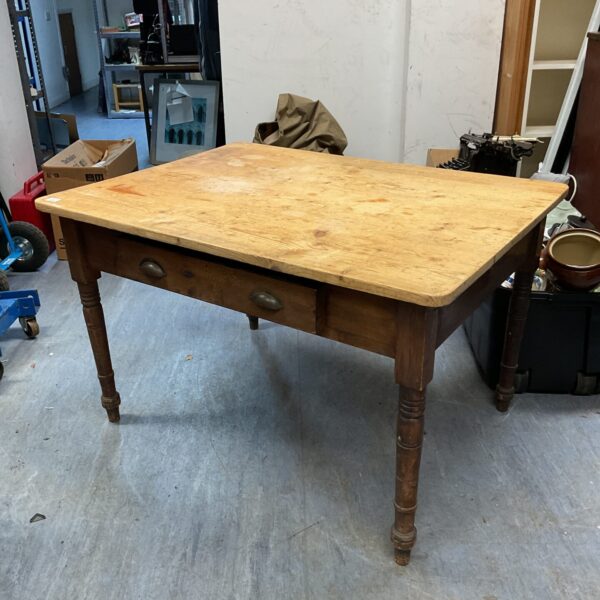 Vintage pine kitchen table with turned legs and rustic finish.