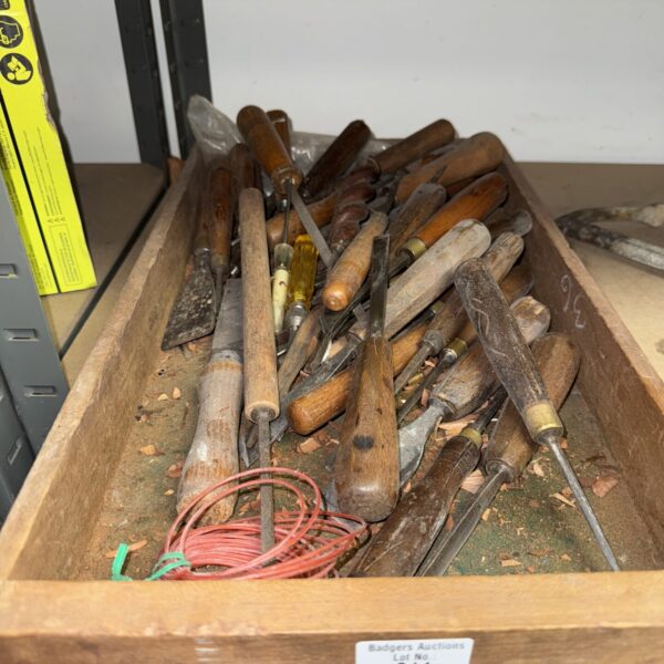 Vintage tool lot with chisels and other workshop implements.