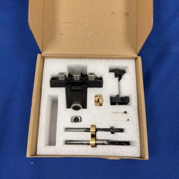 Close-up of the dowel jig kit with drill guide and components.