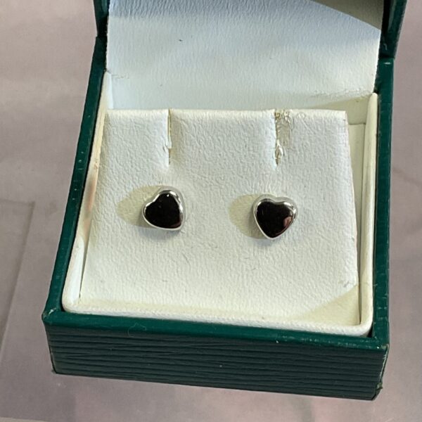 Close-up of 9ct white gold heart stud earrings in a presentation box.