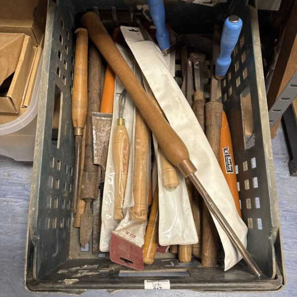 A tray of used wood turning tools for lathe work.