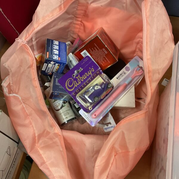 Mixed cosmetic and collectible lot including a Cadbury diecast car.