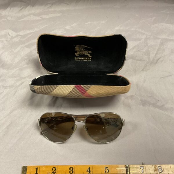 Burberry sunglasses in their original check patterned case.