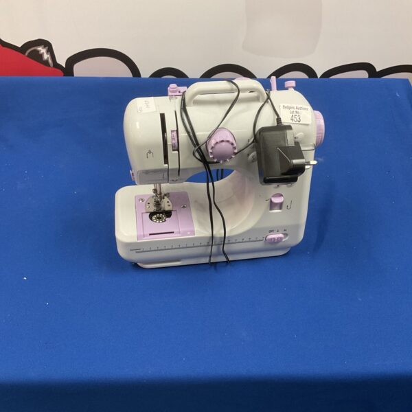 Vintage lilac sewing machine, a retro collectible for display.